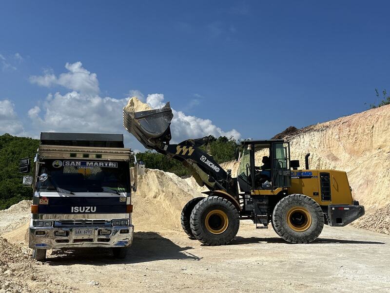 Wheel loader loading construction material